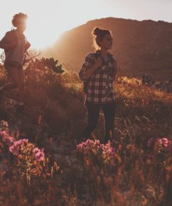 two individuals enjoying the sunset playfully after having WYLD Sour Tangerine Gummies