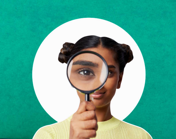 a female holding a magnifying glass close to her right eye looking for wyld gummies near me